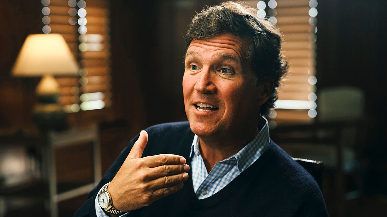 Tucker Carlson speaks with Zanny Minton Beddoes (out of shot) during an interview 