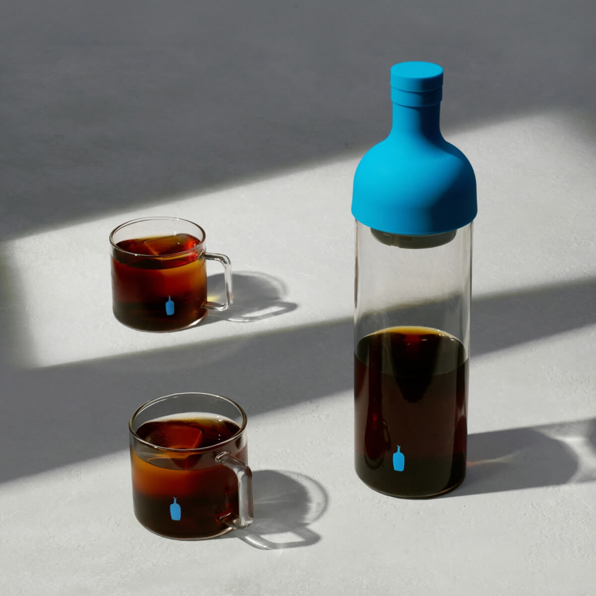 Image of coffee in bottle and cups.