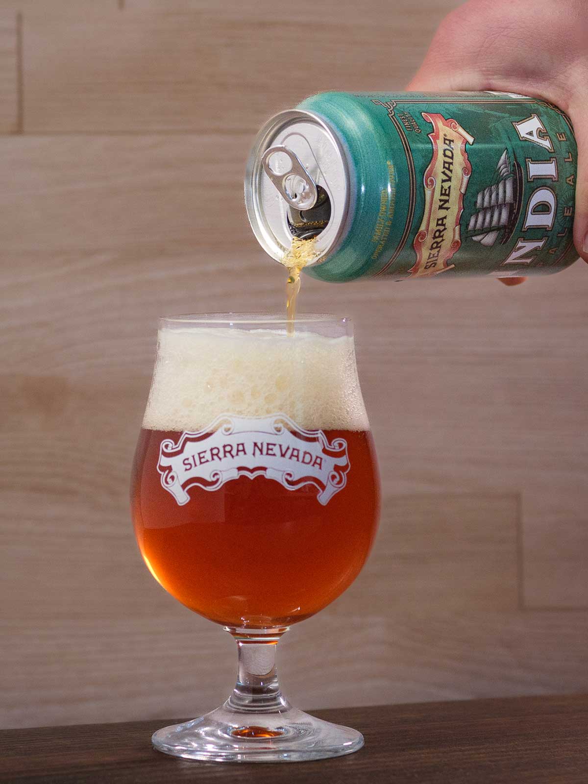 Pouring a can of English-style India Pale Ale into a glass