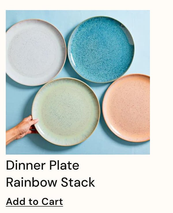 Four colorful dinner plates stacked, with a hand holding one. Background is light blue.