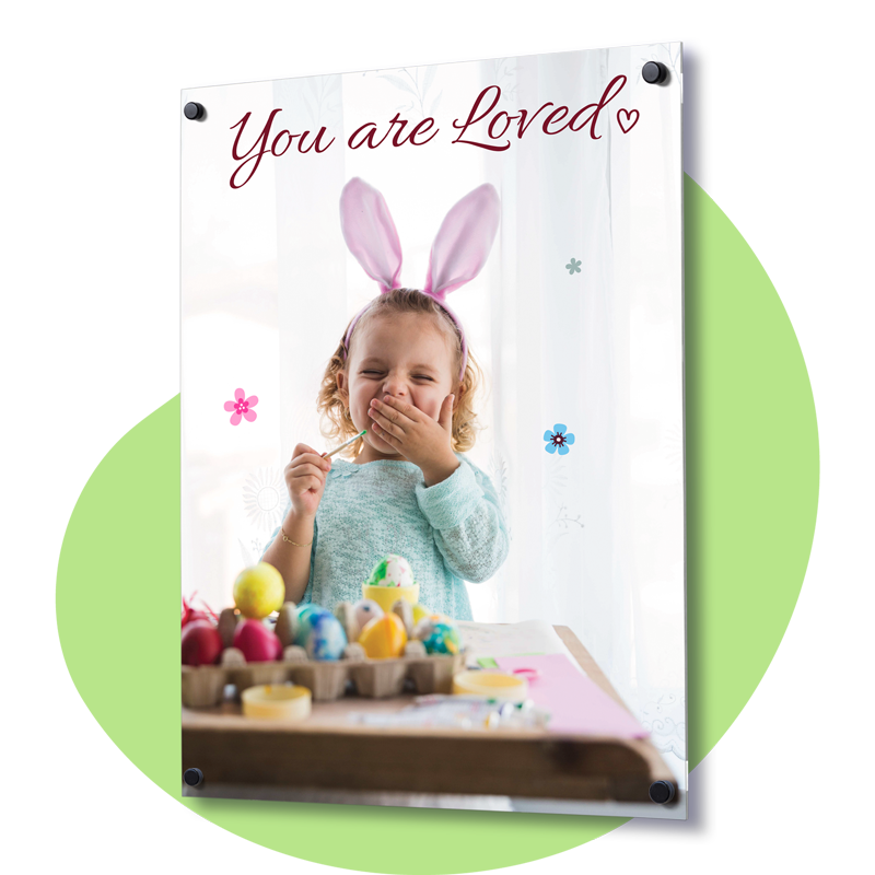 Acrylic wall print of a young girl in bunny ears painting eggs, topped with the cursive text "You are Loved."