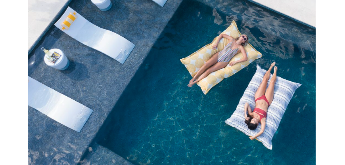 Picture of Ledge Chaise lounger and Laze pool pillows in pool. 