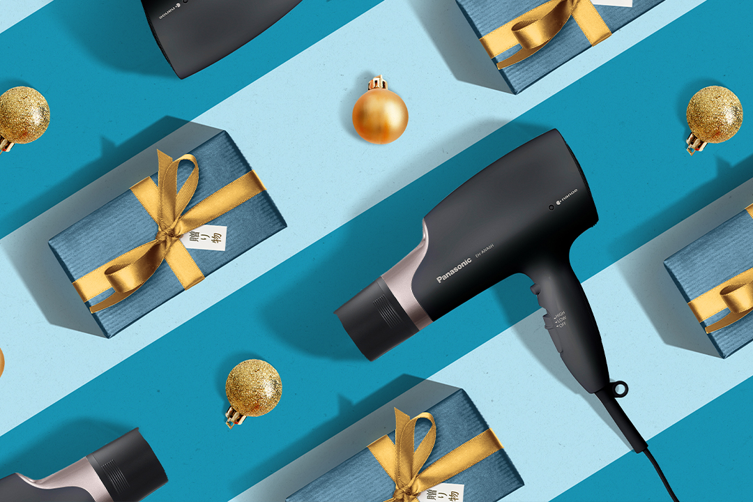 nanoe Hair Dryer arranged with christmas presents on blue background