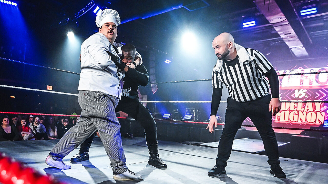 The Superwrestlers wrestle in the ring.