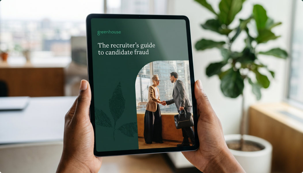 Image-of-someone-holding-the-recruiters-guide-to-candidate-fraud-on-a-tablet-in-office