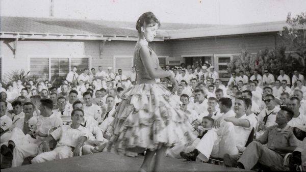 dancer performs as U.S. troops watch