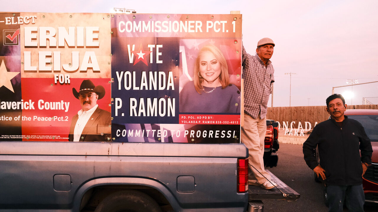 Men standing outside Democratic primary early voting station in Eagle Pass, Texas.