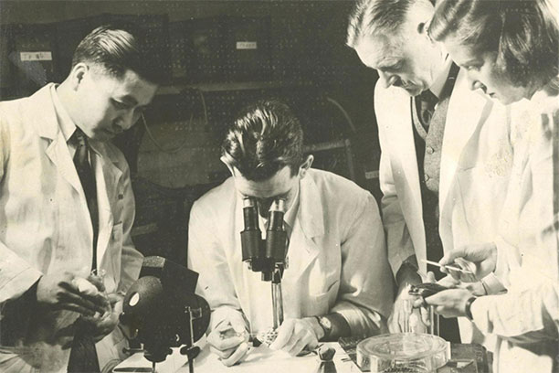 Researchers look through a microscope in a lab at the Hospital of the University of Pennsylvania around 1940. (Image: Courtesy of University Archives)