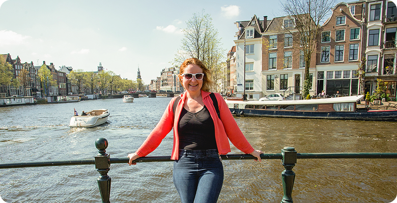 Traveler by an Amsterdam canal on Amsterdam, Bruges & Paris for Solo Travelers — opens itinerary