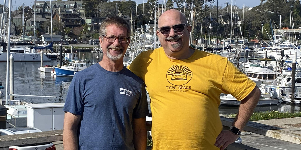 Mike and Tico pose in front of the Santa Cruz harbor.