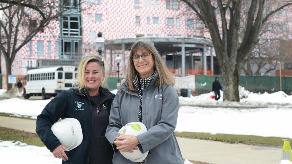 women hold hard hats
