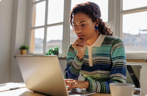 Photo-of-a-woman-thinking-over-laptop-in-office