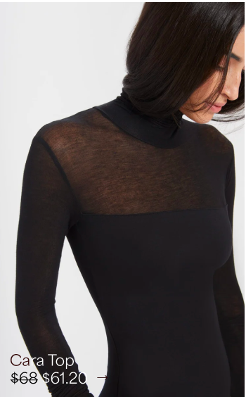 Sam looks down while wearing The Cara Top with a sheer yoke and sleeves.