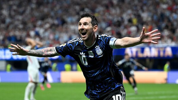 Argentina's Lionel Messi runs with his arms outspread as he celebrates the team’s second goal during the World Cup. 