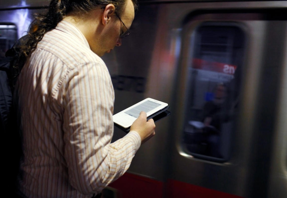 An individual using a Kindle e-reader