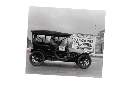 A vintage photo of a car entering the Pennsylvania Turnpike.
