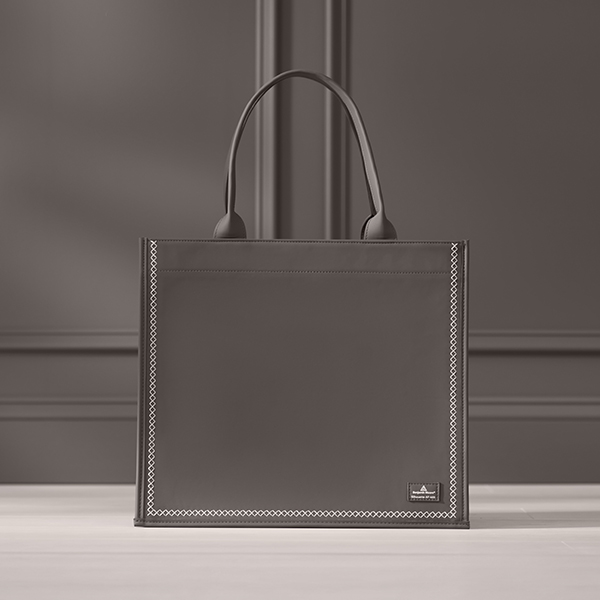 Deep chocolate brown tote bag on a shelf against a wall painted in the same shade.