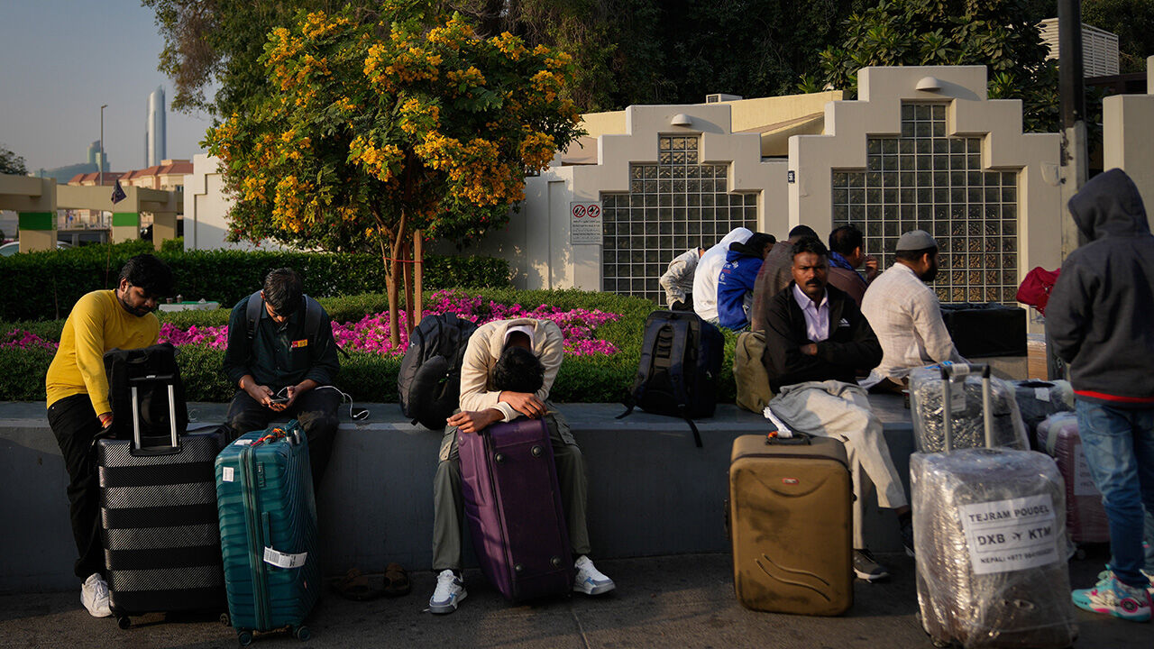 Passengers stranded by the closure of Dubai International Airport wait for assistance in the airport parking lot in Dubai, United Arab Emirates, March 1st 2026