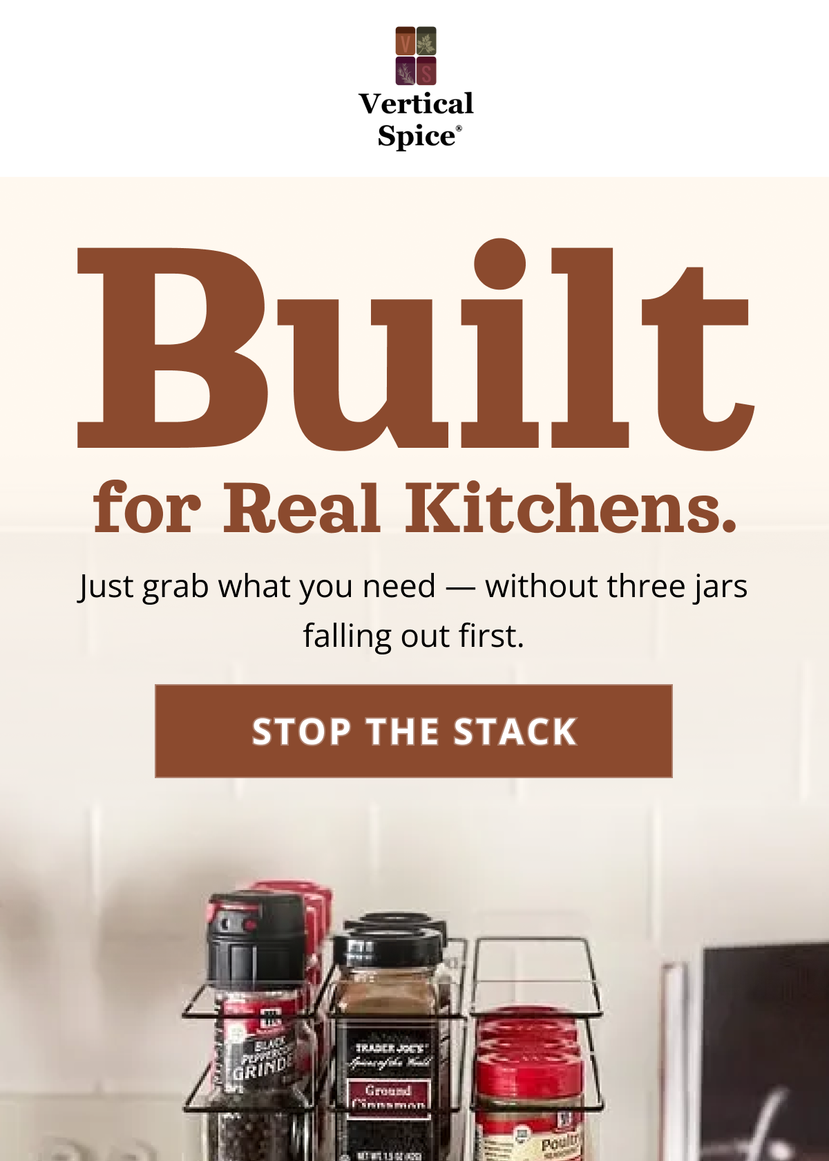 Pull-out spice rack drawer organizer in kitchen cabinet with neatly stored spice jars for easy access