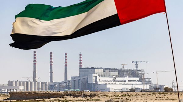 The national flag of the United Arab Emirates flies outide the Hassyan power and water production complex
