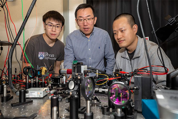(From left) Xilin Feng, Liang Feng, and Tianwei Wu developed a microring array that allows multiple beams of light to travel simultaneously, protected by topology.