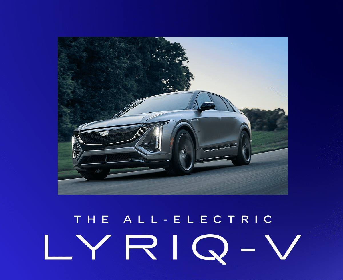 The 2026 LYRIQ-V in Magnus Metal Frost driving down a picturesque road.