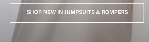 Soft taupe fabric backdrop with "SHOP NEW IN JUMPSUITS & ROMPERS" text. Explore our latest collection of fashionable jumpsuits & rompers.