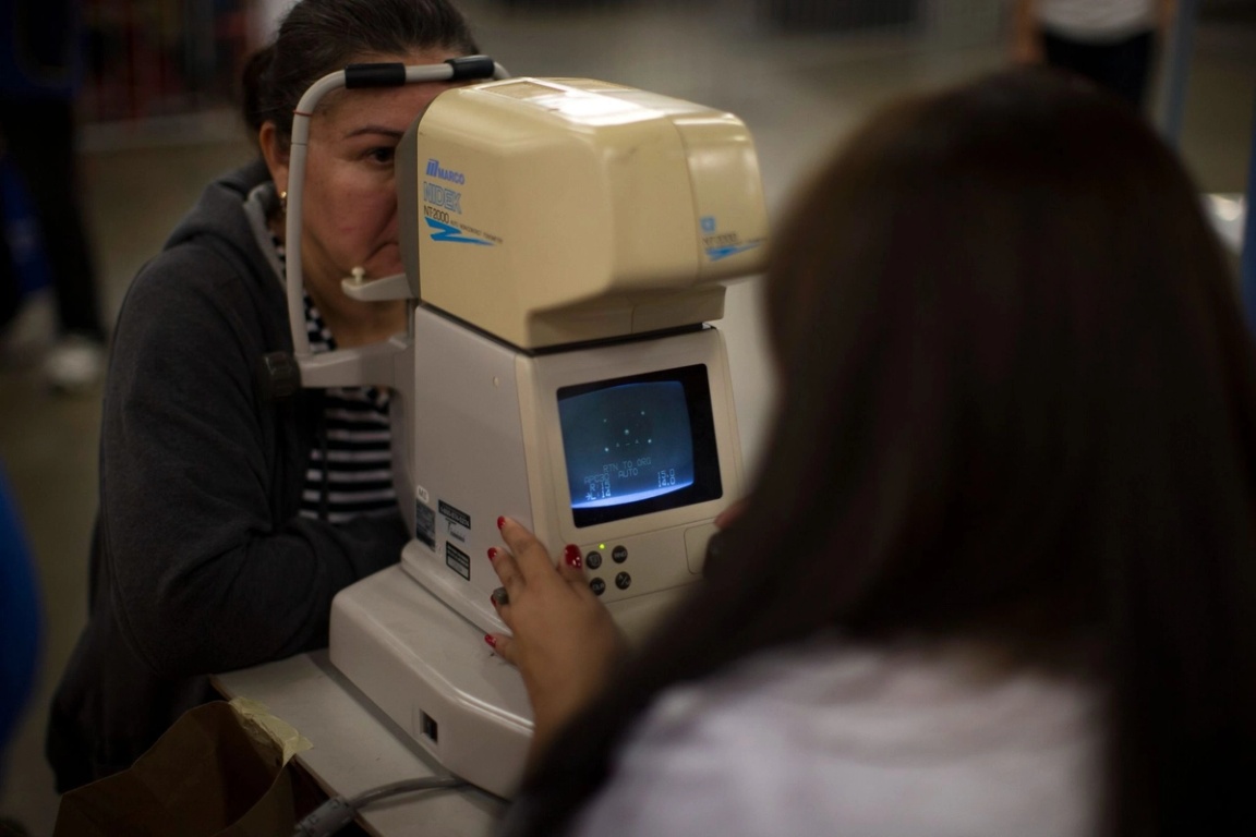 A woman taking a Glaucoma test. 