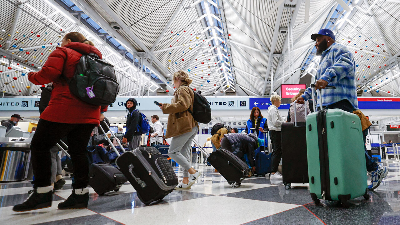 Travelers walk through O'Hare International Airport in Chicago, Illinois.