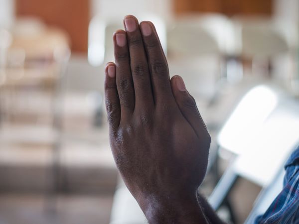 hands raised and joined together in prayer
