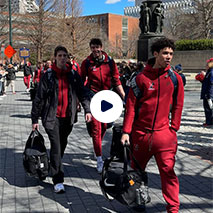The men's basketball team walks to the bus ahead of the March Madness tournament.