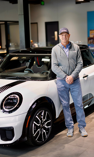 Man posing in front of white MINI