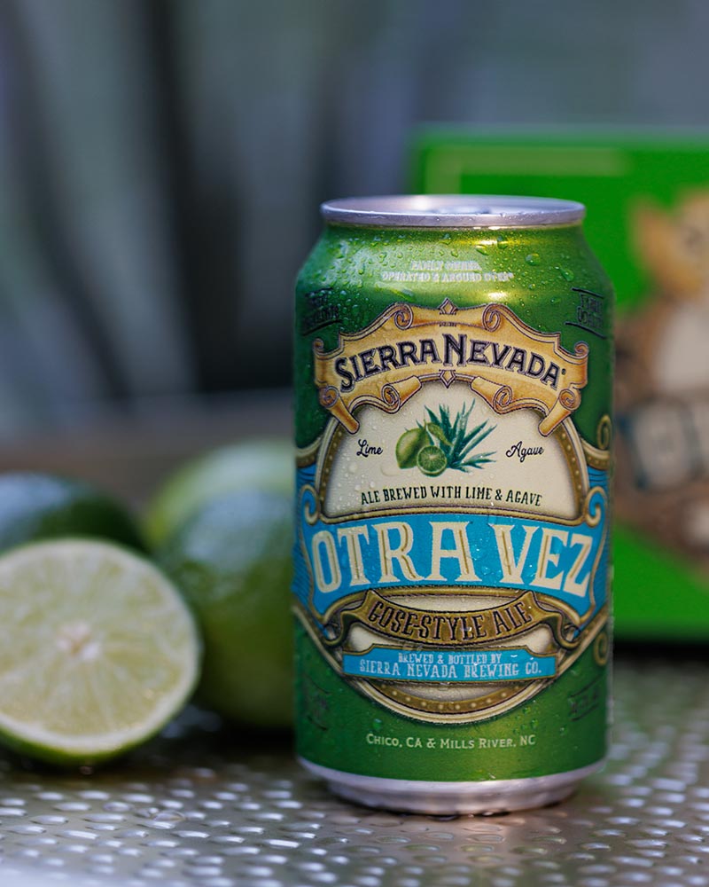 A can of Otra Vez next to several limes
