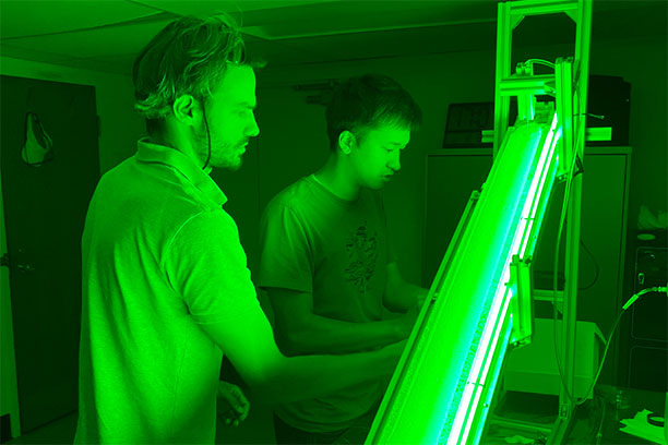 Daisuke Noto (right) and Bertil Trottet work with a custom-built sloped channel used to study how raindrops roll and aggregate sand after impact. The laboratory setup, developed with guidance from Douglas Jerolmack, enabled systematic observation of the peanut- and donut-shaped “sandballs” described in the study. (Image: Hugo Ulloa)