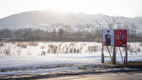 Liberal Democratic Party (LDP) poster boards featuring Japan's Prime Minister Sanae Takaichi stand in the snow in Date, Hokkaido prefecture in northern Japan on February 22, 2026.