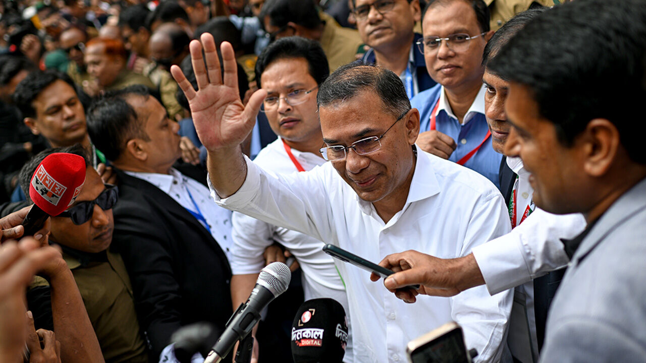 Bangladesh Nationalist Party Chairperson Tarique Rahman waves as he comes out after casting his vote during the national parliamentary elections in Dhaka