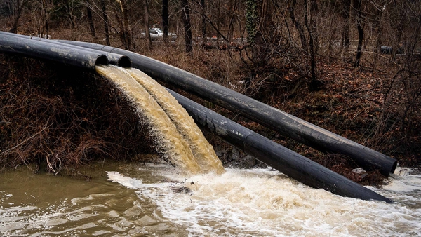 sewage spills from pipe into canal