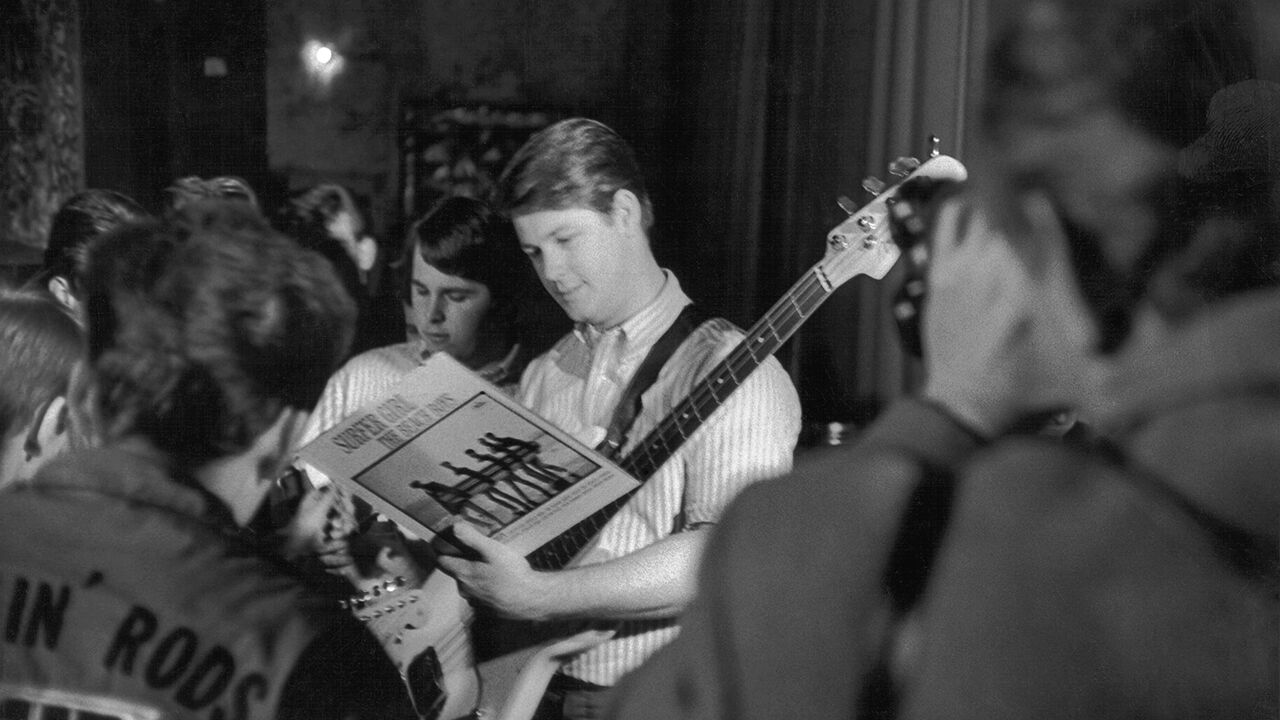  Brian Wilson of the rock and roll band The Beach Boys holds a copy of their 1963 album Surfer Girl in 1964.