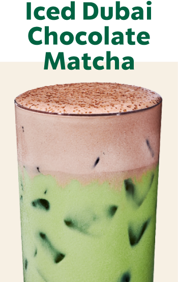 Iced Dubai Chocolate Matcha | Iced matcha drink topped with brown cold foam and dark brown topping in a glass.