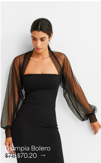Sam with center-parted hair gazes downward in a strapless black dress topped with The Olympia Bolero.