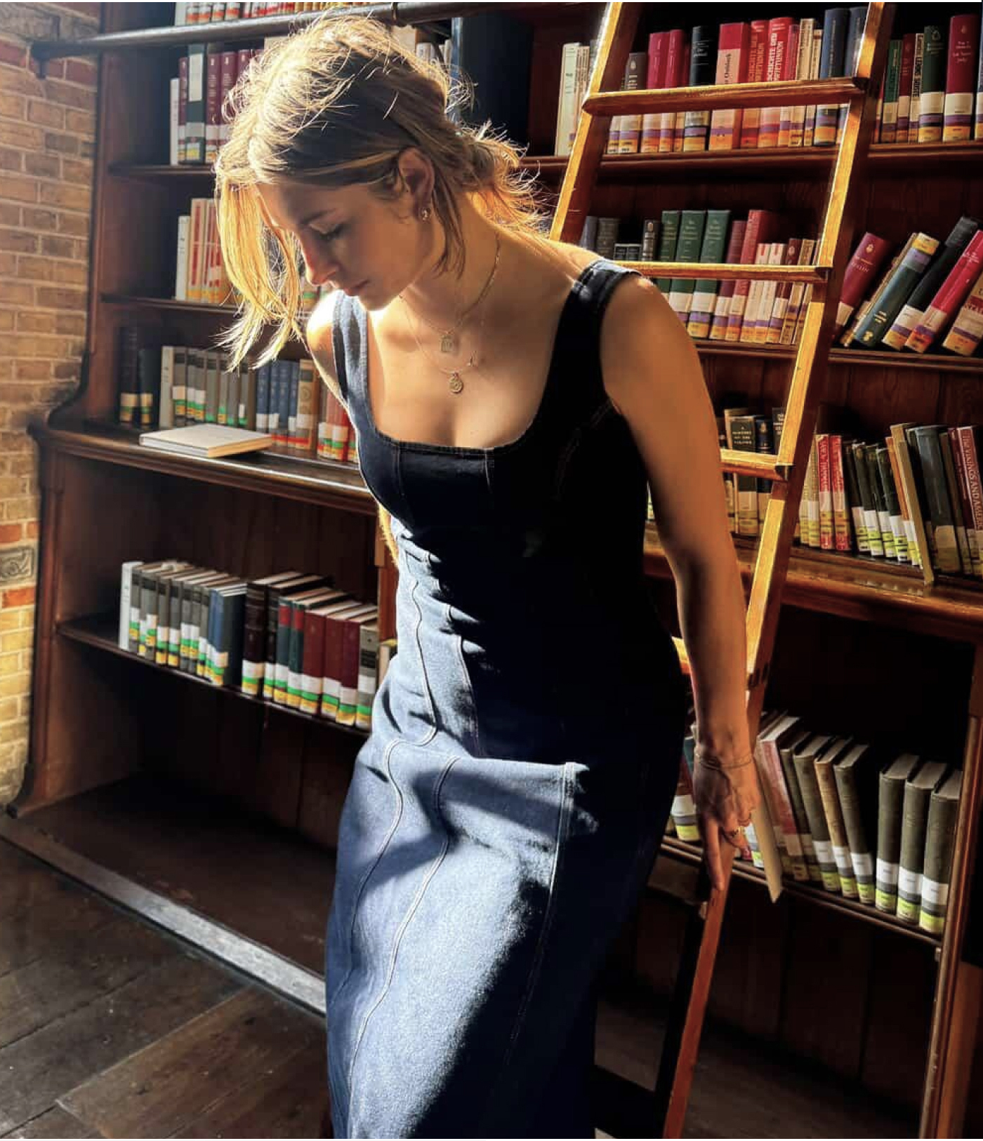 @monicaaksamit models The Melrose Denim Dress with a square neckline and flared hem, priced at $178.