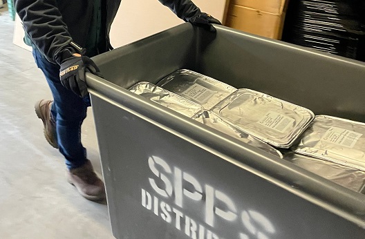 SPPS Bin full of aluminum trays of food