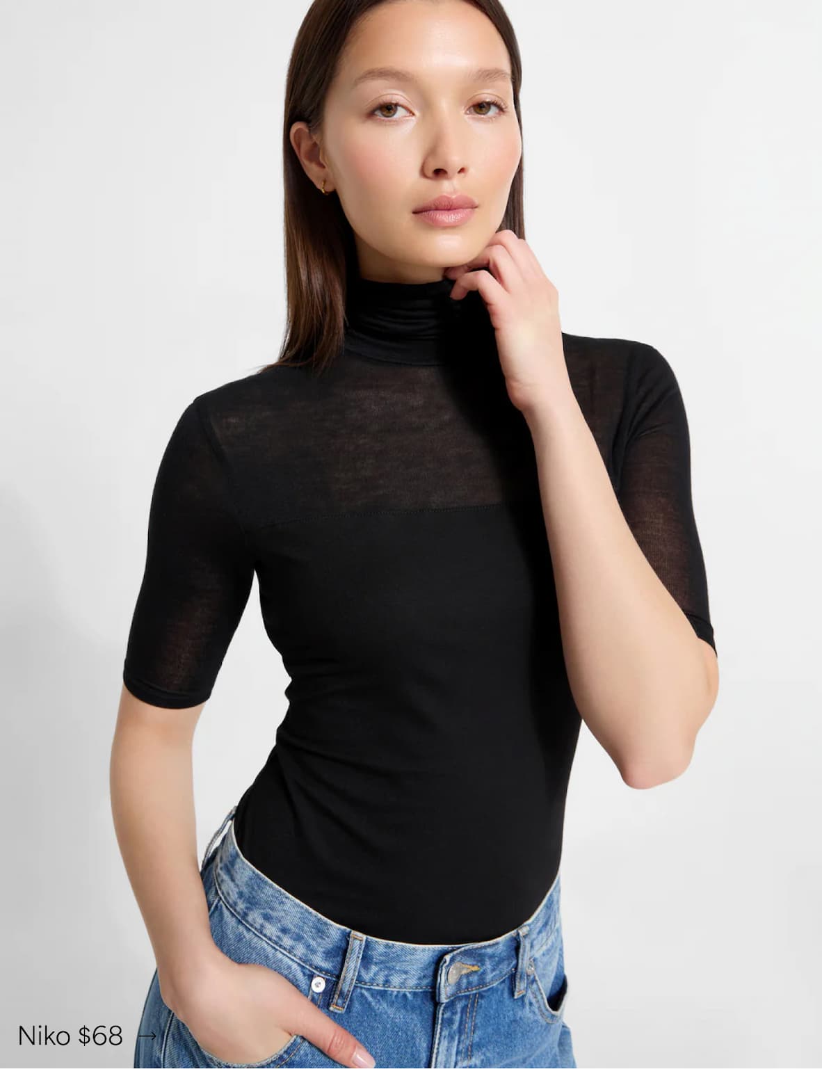 Yada wears The Niko Top with a sheer texture, tucked into high-waisted blue jeans, labeled “Niko $68.”
