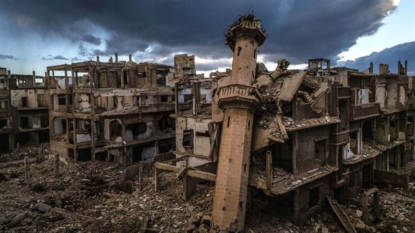 A toppled mosque minaret leaning against destroyed buildings in the Jobar suburb of Damascus, Syria