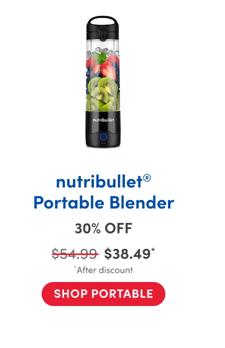 A nutribullet portable blender filled with layers of fresh fruit, including sliced kiwi, blueberries, strawberries, and mint leaves. The blender has a black base with a power button and a carry handle on top.