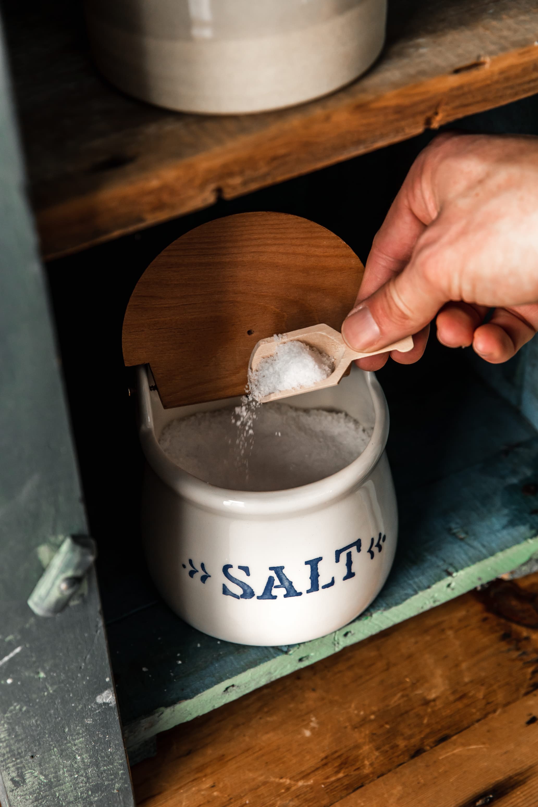 The salt scoop resting in a cellar of coarse salt