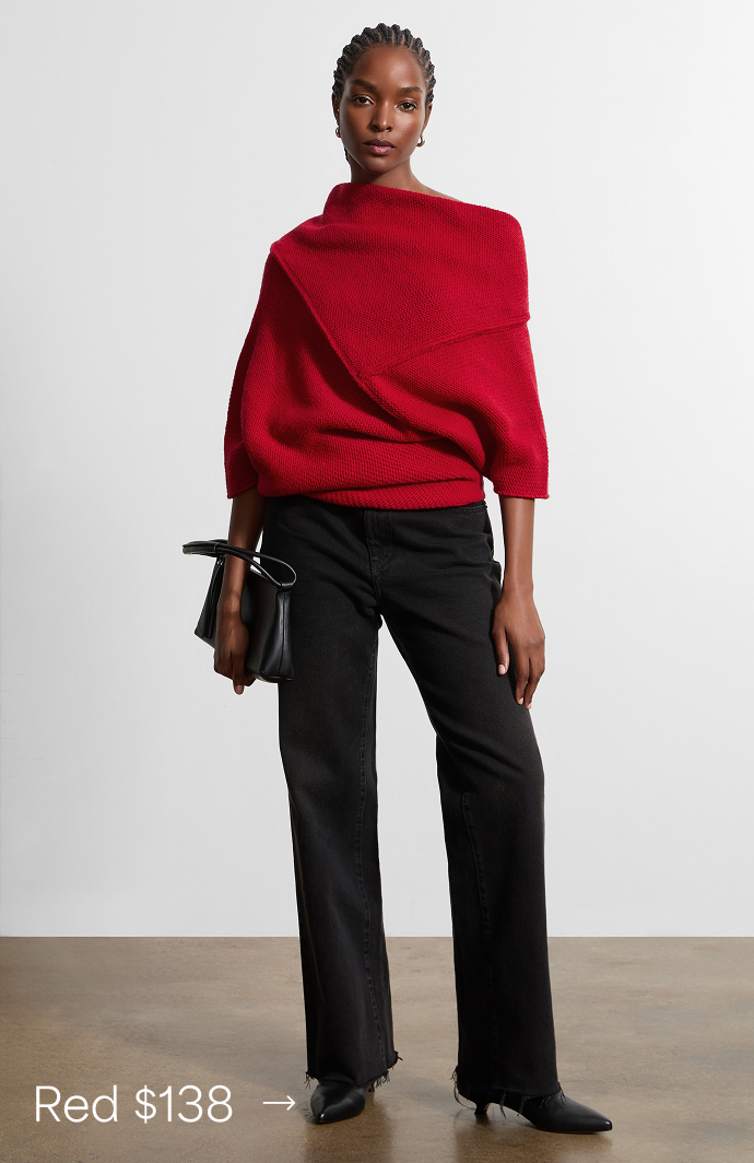 Miqueal stands wearing The Palmer Knit Top in red styled with black pants and a black handbag, priced at $138 →