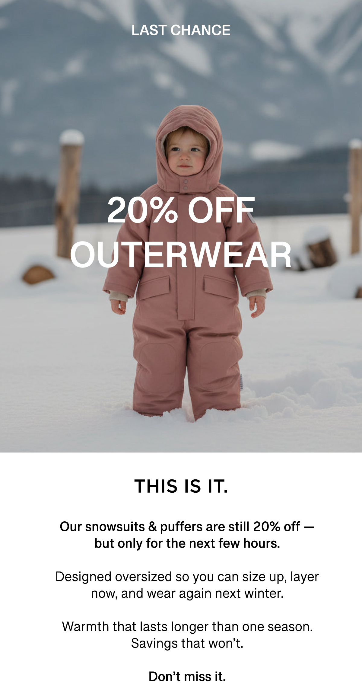 an image of a child in a pink snow suit standing in the snow
