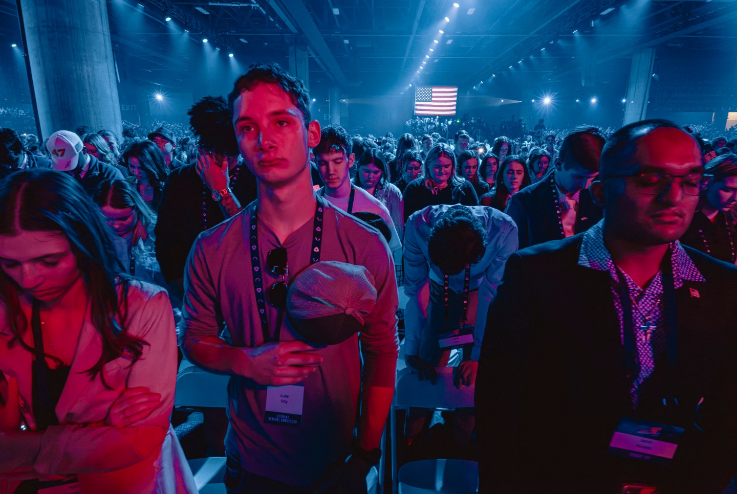 Attendees pray at Turning Point’s annual AmericaFest conference
