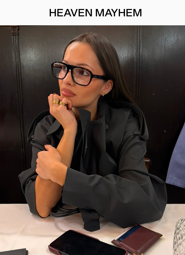 Founder Pia Mance styles Whimsey Ring and Vivi Ring in Gold with Vesper Clear Glasses in Milan cafe. 